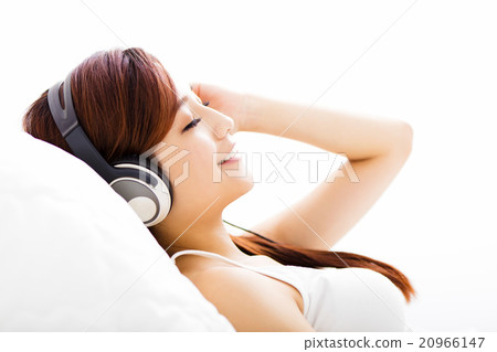 relaxed young Woman with headphones listening music relaxed young Woman with headphones listening music 20966147
