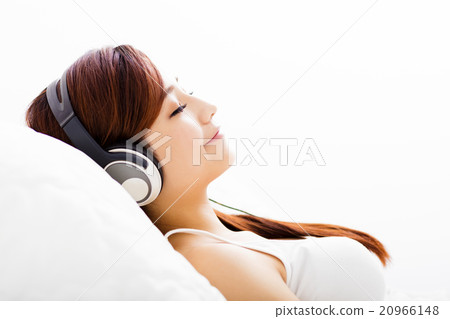 relaxed young Woman with headphones listening music relaxed young Woman with headphones listening music 20966148