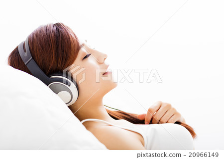 relaxed young Woman with headphones listening music relaxed young Woman with headphones listening music 20966149