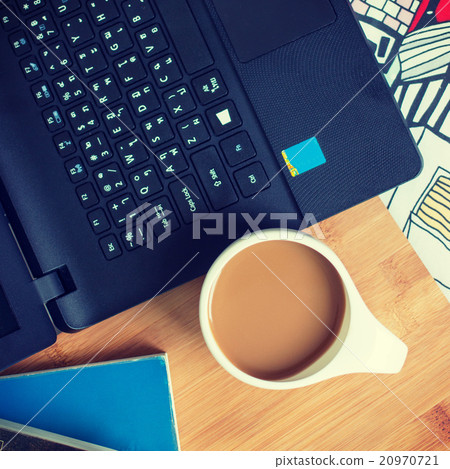 Cup of coffee and laptop on the bed. 20970721