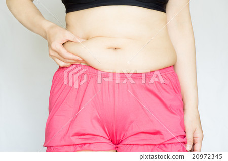 Pinch your tummy fat with your hands 20972345