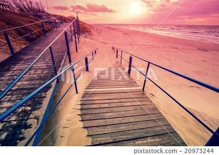 Stairway to the sandy beach at sunset 20973244