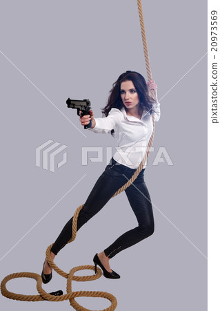 Young  sexy Woman holding Handgun in hand 20973569