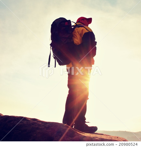 Silhouette of tourist. Sunny daybreak in mountains 20980524