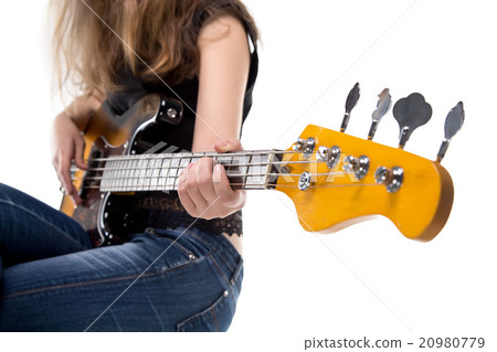 Teenager playing on bass guitar Teenager playing on bass guitar 20980779