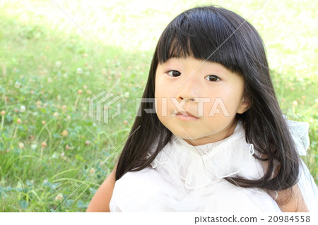 Girl sitting on the lawn 20984558