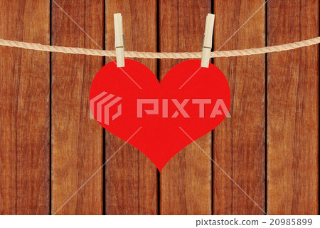 red heart hang on clothespins over wooden planks 20985899