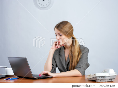Young female executive working on laptop Young female executive working on laptop 20986486