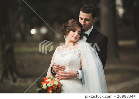 Stylish couple of happy stylish newlyweds walking 20988344