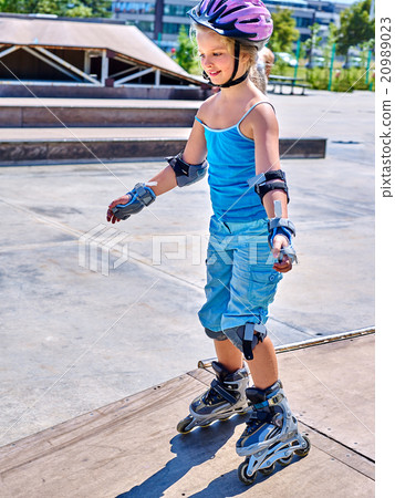 Girl riding on roller skates . Girl riding on roller skates . 20989023