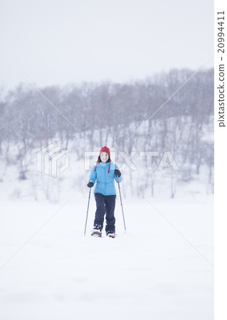 A woman taking a snowshoe A woman taking a snowshoe 20994411