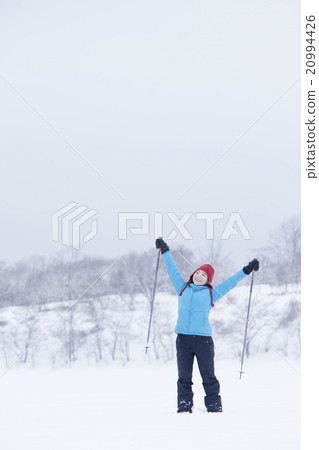 A woman taking a snowshoe A woman taking a snowshoe 20994426