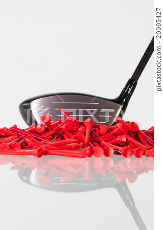 Golf driver and wooden tees on a glass desk Golf driver and wooden tees on a glass desk 20995427