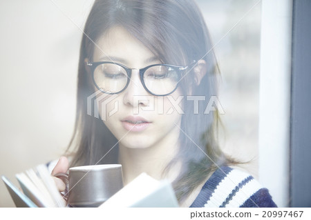 A woman with a coffee cup A woman with a coffee cup 20997467