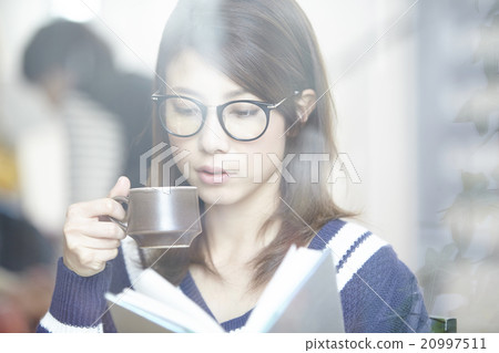 A woman with a coffee cup 20997511