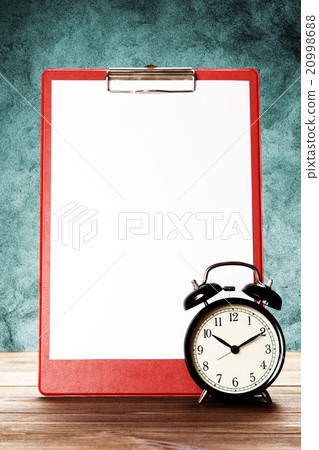 Blank paper sheet and alarm clock 20998688
