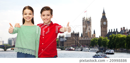happy boy and girl showing thumbs up over london happy boy and girl showing thumbs up over london 20998886