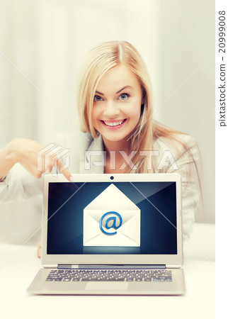 woman with laptop pointing at email sign woman with laptop pointing at email sign 20999008