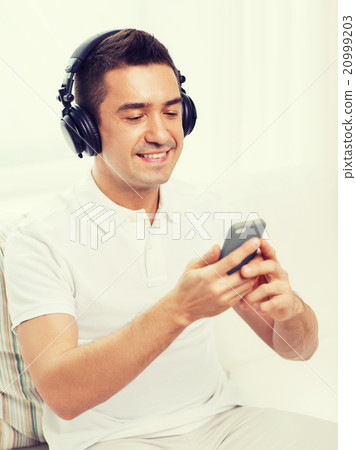 happy man with smartphone and headphones happy man with smartphone and headphones 20999203