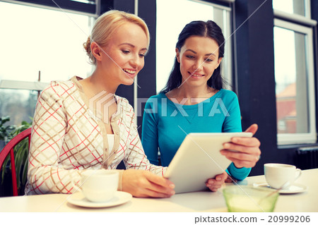 happy young women drinking tea or coffee at cafe happy young women drinking tea or coffee at cafe 20999206