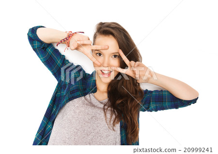 happy smiling teenage girl showing peace sign happy smiling teenage girl showing peace sign 20999241