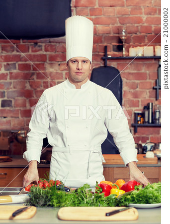 happy male chef cook with vegetables in kitchen happy male chef cook with vegetables in kitchen 21000002