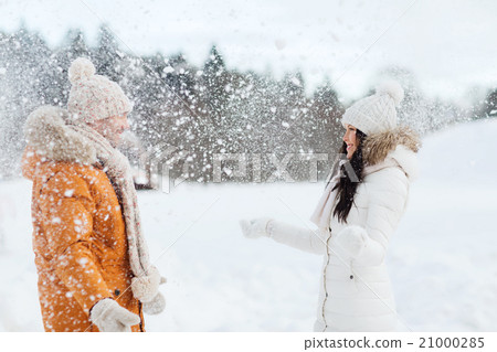 happy couple playing with snow in winter 21000285