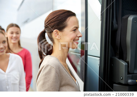group of happy passengers boarding travel bus 21000339