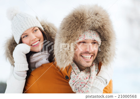 happy couple having fun over winter background 21000568