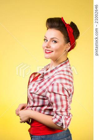 Beautiful young woman with pin-up make-up and 21002646