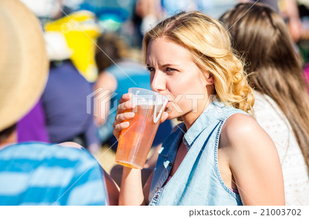 Young blond woman with beer at summer music Young blond woman with beer at summer music 21003702
