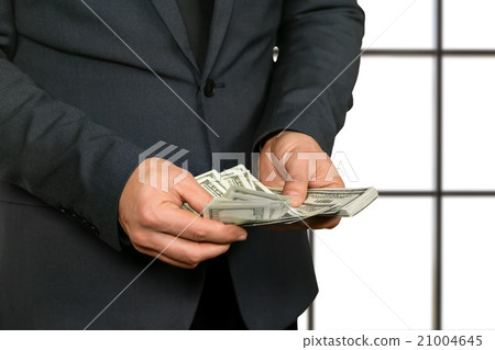 Adult office worker counting cash. 21004645