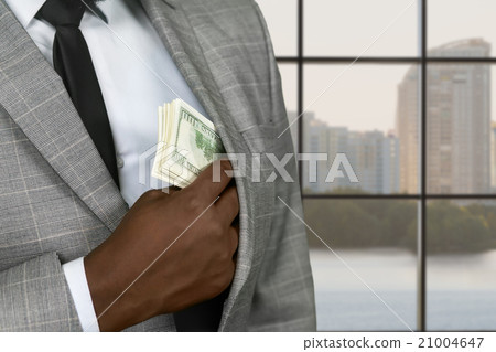Afro office executive hiding money. Afro office executive hiding money. 21004647