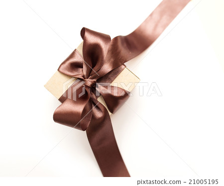 Gift box with brown bow on a white background Gift box with brown bow on a white background 21005195