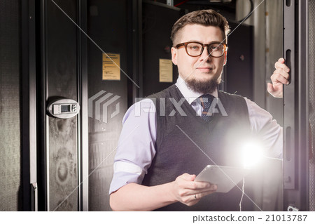 Young engineer in a datacenter Young engineer in a datacenter 21013787