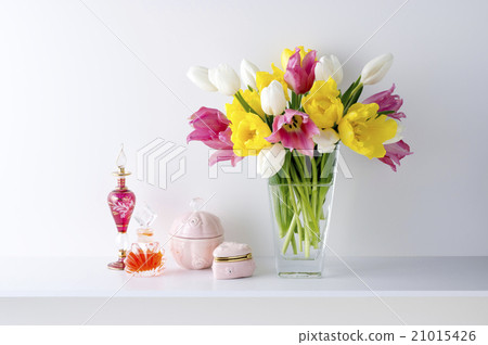 Perfume bottle with white background and three color tulips and vessels 21015426