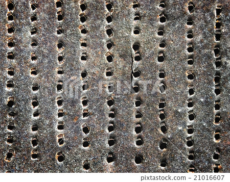 old rusty iron sheet with holes as a background 21016607