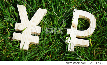 Exchange currency unit on a grass background Exchange currency unit on a grass background 21017339