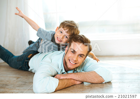 Little boy and his father on wooden floor Little boy and his father on wooden floor 21021597