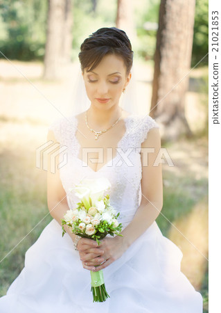 Brunette bride in a beautiful white dress Brunette bride in a beautiful white dress 21021853