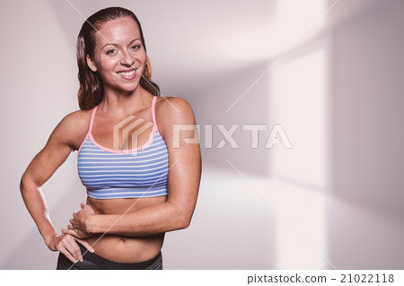 Composite image of portrait of smiling athlete with hands on hip 21022118