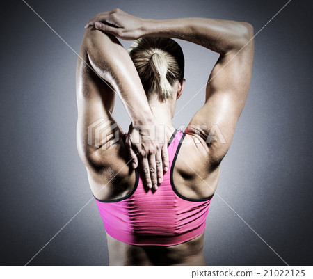 Composite image of muscular woman stretching her arms 21022125