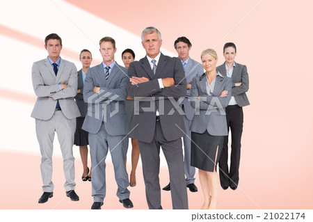 Composite image of business team standing arms crossed Composite image of business team standing arms crossed 21022174