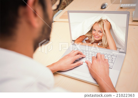 Composite image of smiling woman under a duvet 21022363