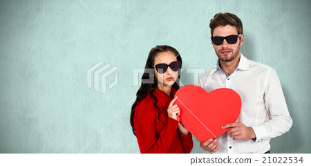 Composite image of portrait of couple with sunglasses holding pa Composite image of portrait of couple with sunglasses holding pa 21022534