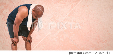 Composite image of fit man taking a break from working out 21023015
