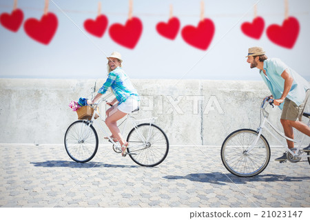 Composite image of cute couple on a bike ride 21023147