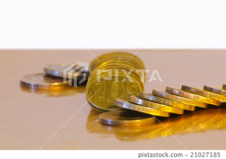 Stack of coins close-up on a gold background Stack of coins close-up on a gold background 21027185