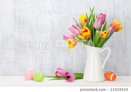 Easter eggs and colorful tulips bouquet 21028428