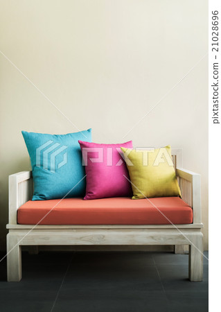 Colorful 3 pillows on a white chair 21028696